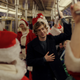 Austin Abrams and a whole bunch of Santas